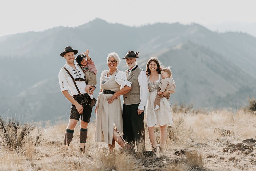 The Boyd family — three generations in traditional Bavarian attire with the Cascade Mountains behind them in Leavenworth, Washington